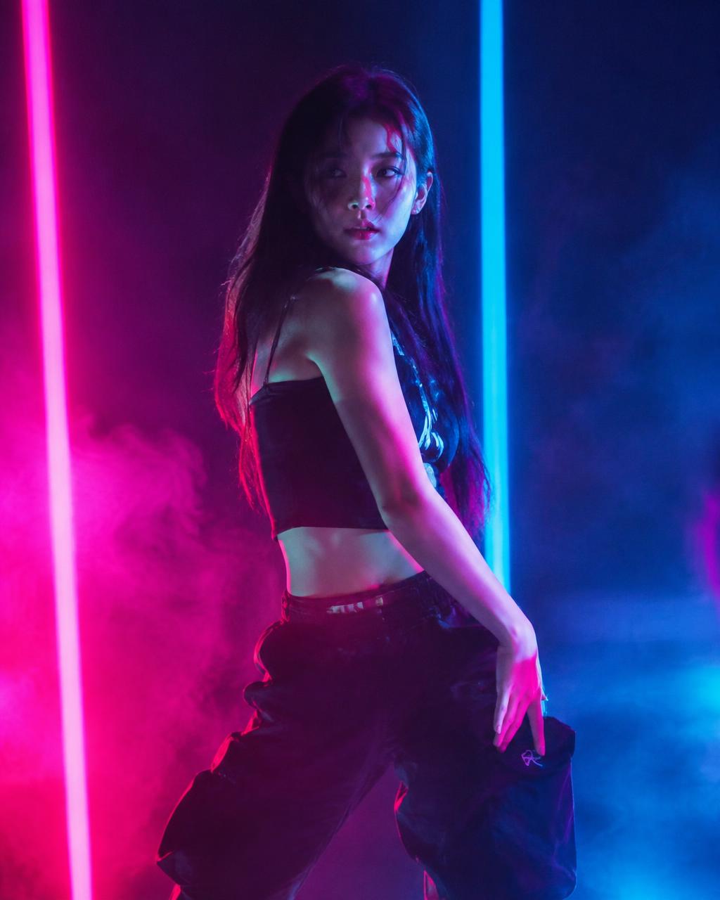 Trainee dancing under neon stage lights